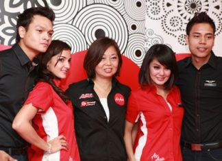 AirAsia’s Group Head of Commercial, Kathleen Tan with AirAsia flight attendants in their new weekend uniforms.
